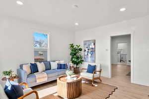 Living room featuring wood finished floors and recessed lighting