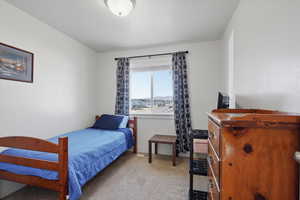 Bedroom 3 featuring light carpet and window