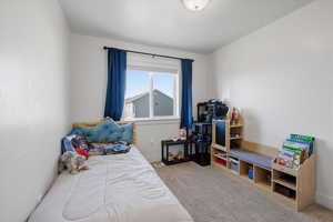 Bedroom 2 featuring light colored carpet and large window