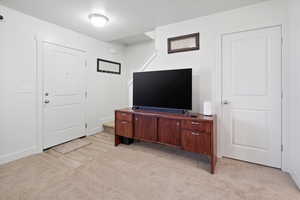 Living area featuring storage under the stairs