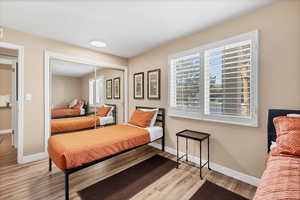 Bedroom with light wood-style flooring and a closet