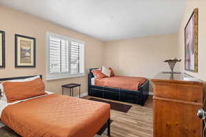 Bedroom featuring light wood finished floors and a textured ceiling