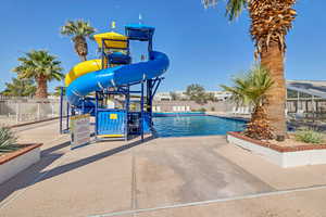Community pool featuring a water slide