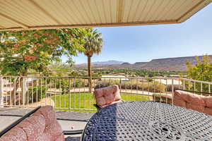 Patio / terrace featuring a lawn and a mountain view