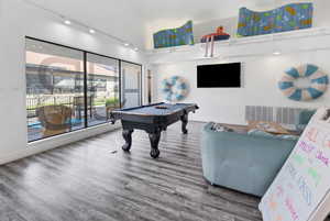 Recreation room featuring pool table and high vaulted ceiling