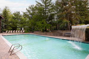 Community pool featuring a patio area