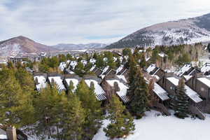 Snowy aerial view with a mountain view and a residential view