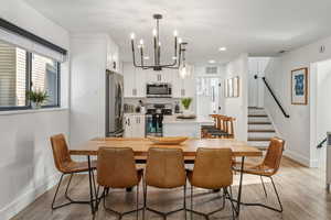Dining space featuring light wood-style floors and a chandelier