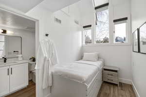 Bedroom featuring light wood-style flooring and a sink