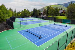 View of tennis court featuring a mountain view