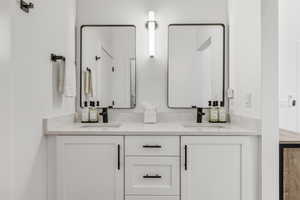 Full bath featuring double vanity