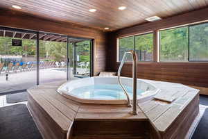 View of swimming pool with an indoor hot tub