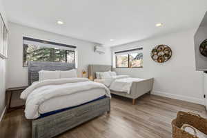 Bedroom with light wood-type flooring and recessed lighting