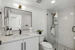 Full bathroom featuring a shower stall and vanity
