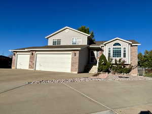 View of front of property featuring brick siding, concrete driveway, and a shingled roof