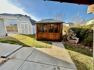 View of shed with a fenced backyard