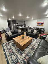 Living area with a textured ceiling and light wood-type flooring