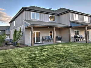 Rear view of property featuring a patio area and a yard