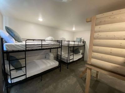 Bedroom with rustic walls and concrete floors