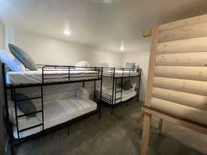 Bedroom with rustic walls and concrete floors