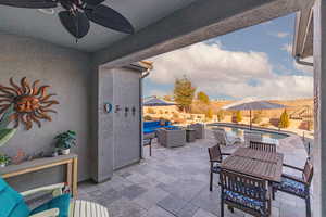 Covered patio with fenced backyard, outdoor lounge area, a patio area, and a ceiling fan