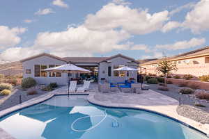 View of swimming pool featuring a fenced backyard, an outdoor lounge area, and patio surround