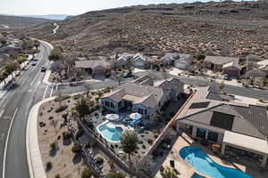 Aerial view of residential area with a pool area and a mountain backdrop