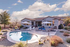 View of swimming pool with an outdoor lounge area, patio surround, and a fenced backyard