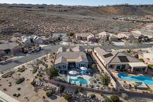Aerial perspective of suburban area with a pool area and a mountain backdrop