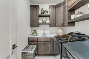 Laundry room with washing machine and clothes dryer and cabinet space