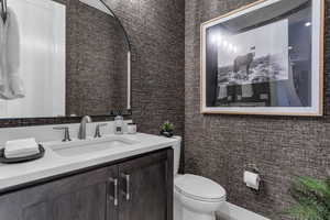 Half bath featuring vanity and toilet