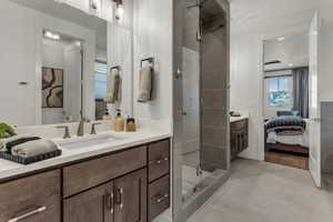 Bathroom with ensuite bath, vanity, and a stall shower