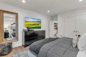 Bedroom featuring wood finished floors, a closet, and recessed lighting
