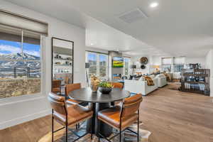 Dining area featuring light wood-type flooring, recessed lighting, and a textured ceiling