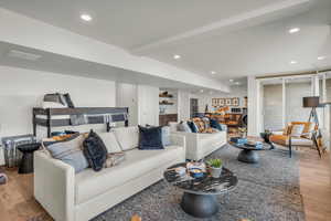 Living room featuring light wood-style floors, recessed lighting, and washer / dryer