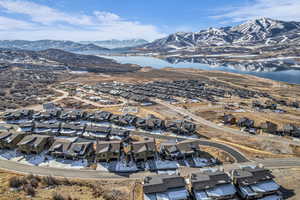 Aerial view of property's location with nearby suburban area and a water and mountain view