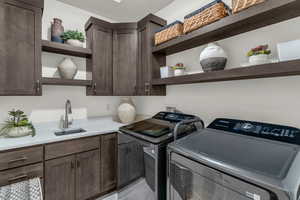 Laundry room featuring cabinet space and separate washer and dryer