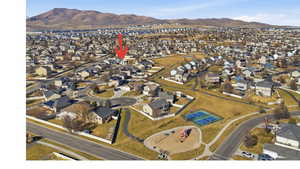 Aerial overview of property's location featuring nearby suburban area and a mountainous background