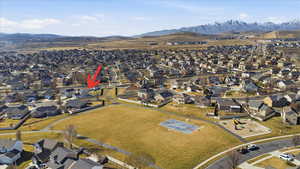 Aerial perspective of suburban area featuring a mountainous background