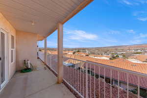 Balcony featuring a residential view and a mountain view