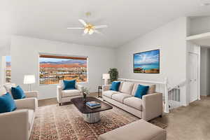 Carpeted living room with vaulted ceiling, a mountain view, and ceiling fan