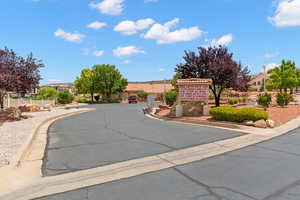 View of asphalt road with a residential view and curbs