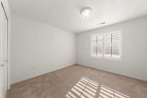 Spare room with baseboards and carpet