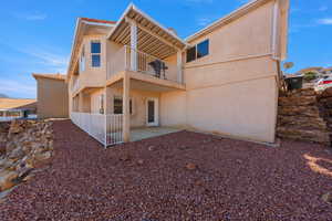 Back of house with a patio, stucco siding, and a balcony