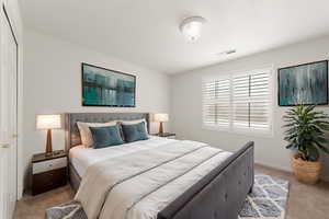 Bedroom featuring carpet flooring and baseboards