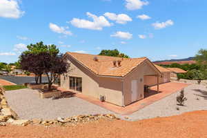 View of property exterior with stucco siding and a tiled roof