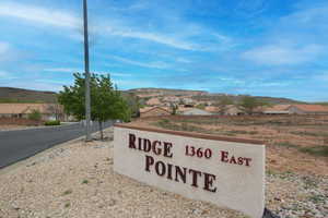 Community / neighborhood sign featuring a mountain view and a residential view