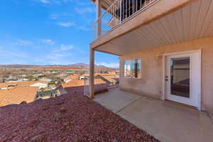 View of yard with a patio, a mountain view, a residential view, and a balcony
