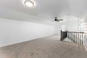 Unfurnished room with light carpet and a ceiling fan