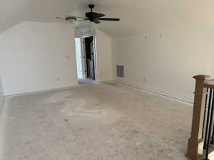 Additional living space featuring a ceiling fan and lofted ceiling